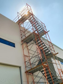 Industrial Construction Scaffolding and Ladder Along Building
