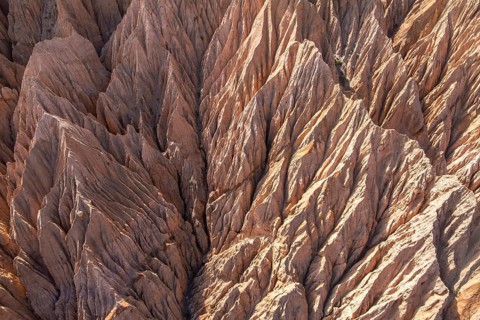 Aerial photograph showcasing the intricate patterns of gully erosion carved into a dry and rugged