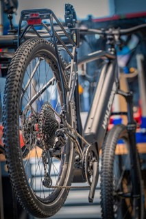 Black bicycle from behind, focussed on the rear wheel in a workshop, Waldbike Manufaktur, bicycle