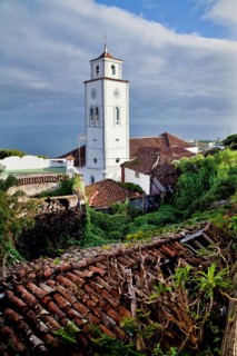 El Tanque showcases its charm with a historic church tower rising above traditional tile roofs and
