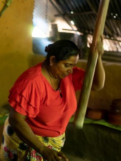 Sinhala woman pounding rice, Sri Lanka