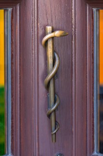 Brass Aesculapian staff as a door handle on a pharmacy, Erlangen, Middle Franconia, Bavaria,