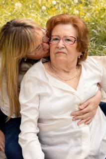 A touching moment between a mother and daughter enjoying time together in a sunny park. The