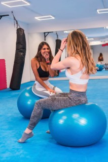 Lifestyle of Friends training in a gym, sport and wellness of salur. A Latin girl and a Caucasian