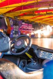 A bumper car steering wheel in a colourful, covered hall at a carnival, Weil der Stadt, Böblingen