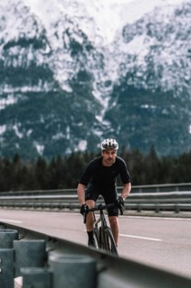 Road bike rider in spring between Lechtal and Tannheimer Tal in front of picturesque scenery of the