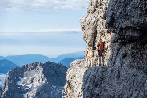 Climbers on a rock band, Bocchette Centrale band trail, via ferrata in the Brenta Mountains,