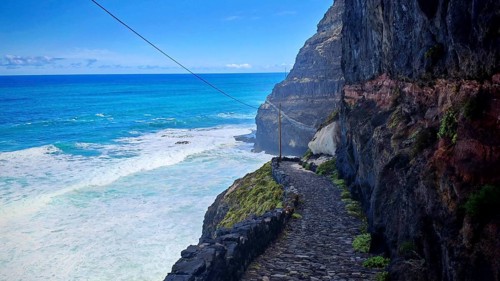 Narrow stone trail, volcanic stone hiking trail along high cliffs with sea views, hiking, Marinha