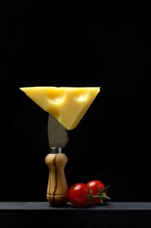 A piece of Swiss Emmental cheese on a cheese knife