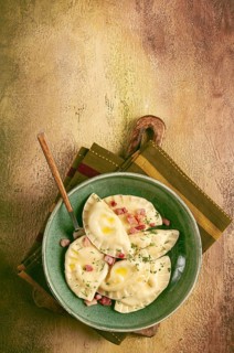 Dumplings, with fried prosciutto, a traditional dish of Polish cuisine, dumplings, top view,