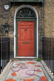 House entrance with red door and decorative mosaic path, Doughty Street, Holborn, London Borough of