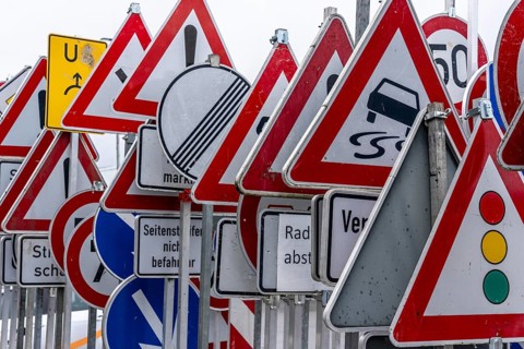Storage for traffic signs in the yard of a road maintenance department, various signs with