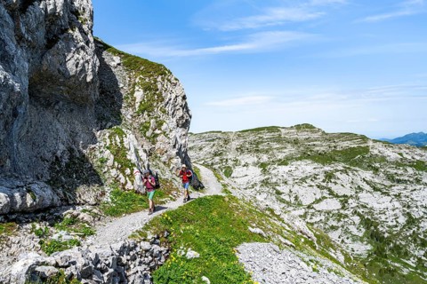 Hikers on a hiking trail on the Schynige Platte, picturesque mountain landscape, Bernese Alps,