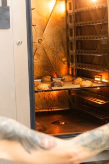 Freshly baked Italian pastries in a warmly lit, rustic oven evoke the authentic charm and