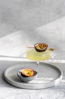 A stylish cocktail made with tonic, gin, and passion fruit juice served in an elegant glass. A