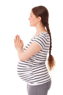 Pregnancy yoga exercise, pregnant woman doing asana adasana namaste -Mountain pose with salutation
