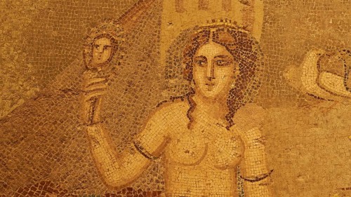 Ancient mosaic depicting the goddess Aphrodite with a mirror in decorative hair in front of a