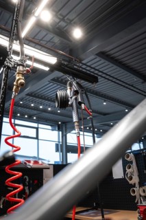 Modern bicycle workshop with hanging air tube and tools, bright industrial lighting, Waldbike