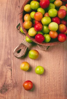 Cherry plum tkemali, fruit, plum variety, in a wooden plate, Georgian cuisine, top view, no people