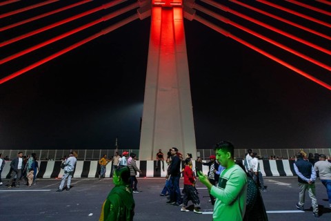 People gather on the newly inaugurated Kumar Bhaskar Varma Setu, a six-lane cable styled bridge