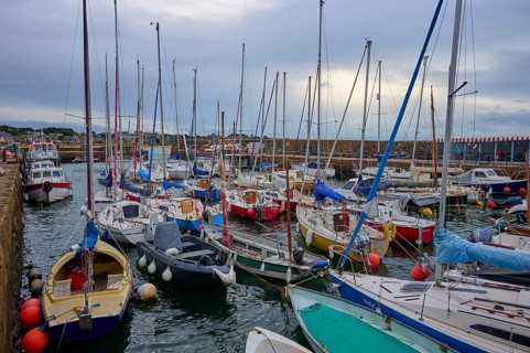 Small harbour with numerous sailboats and yachts under a cloudy sky, North Berwick, East Lothian,