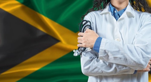 Healthcare professional with Jamaica flag background. Professional doctor holding stethoscope on