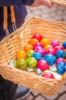 Woven basket filled with colorful Easter eggs is carried, Easter campaign, Sindelfingen, Böblingen