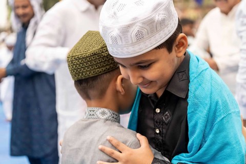 Muslims greets eachother after attend to Eid al-Fitr prayer at Eidgah, on March 21, 2026 in