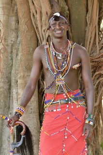 Maasai warrior wearing traditional dress, near Enkutoto, Masai Mara, Rift Valley Province, Kenya