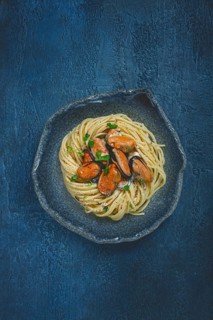 Spaghetti with mussels, without shell, pasta with peeled mussels, in carbonara sauce, micro-greens,