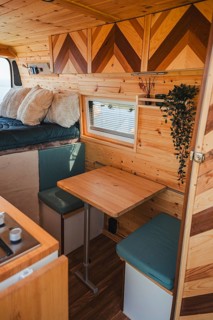 Experience comfort and functionality with this cozy camper interior, perfect for travel enthusiasts