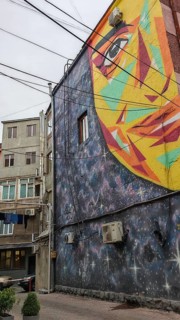 Colourful wall painting with face image on an urban building, Yerevan, Armenia