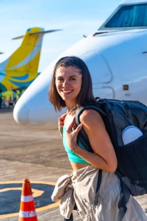 Young woman tourist is arriving at the airport on coron island, ready to start her philippines