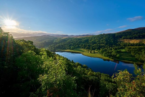 A picturesque landscape with a lake and trees at sunrise, Queens View, Fincastle, Pitlochry,