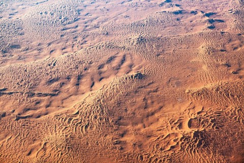 Homogeneous desert surface with wave-like structures extending over a large area, The dunes of the