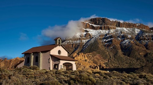 Ermita de las Nieves, small chapel against an impressive snow-covered mountain backdrop, Teide,