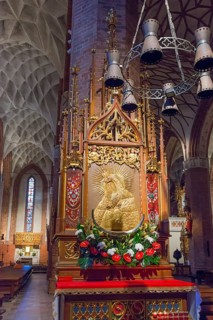 Magnificently decorated altar in a Gothic church with golden elements, St Jakobi Church, Olsztyn,