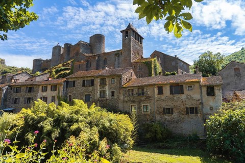 A picturesque Chateau brousse castle medieval rises above a charming village in france, nestled in