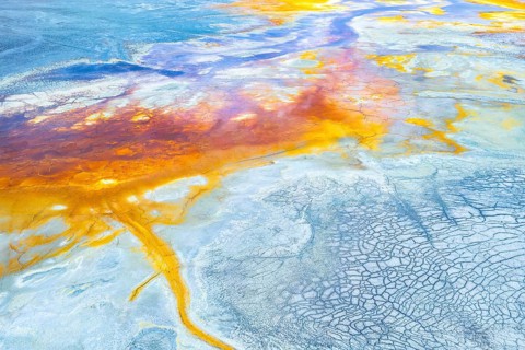 This image captures a stunning aerial view of a multicolor abstract landscape, showcasing vibrant