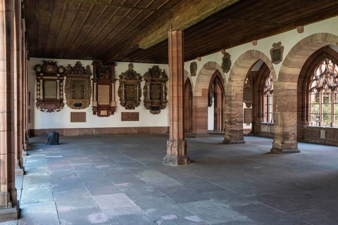 The large cloister of Basel Cathedral with numerous memorial plaques commemorating Basel