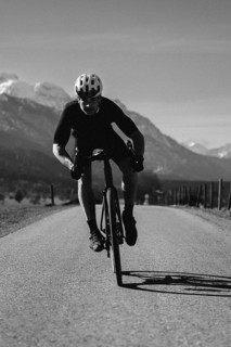 Road bike rider in spring near Halblech in the Allgäu in front of a picturesque backdrop of the