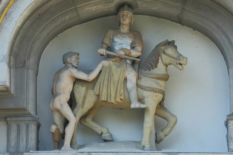 Good Samaritan with horseman, symbol of help, charity, giving, need, aid, equestrian figure, stone