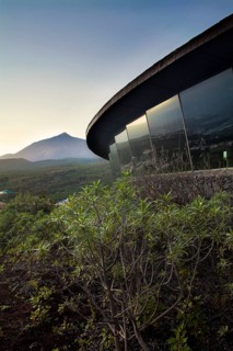 Landscape view of Mount Teide from a modern glass building in El Tanque, Tenerife, showcasing the