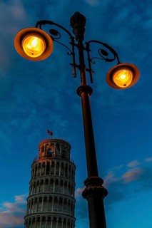 The Leaning Tower under an illuminated street lamp in the evening light, Pisa, Tuscany, Italy