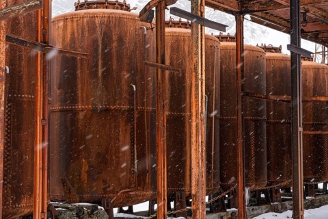 Rusted oil kilns and storage tanks of the former whaling station, snowfall, Grytviken, South