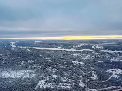 View of the snowy town of Rovaniemi with the Kemijoki river, in winter, aerial view, Finland