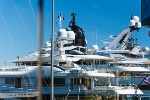 Reflection of a luxury yacht in a window pane in the harbour of Tarragona