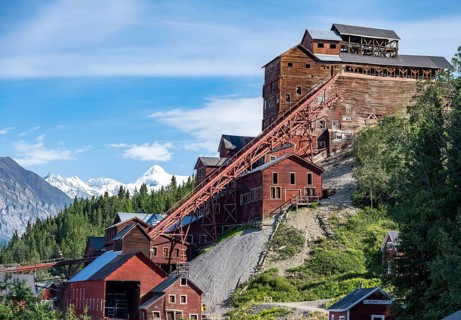 Red Kennicott buildings in front of mountainous landscape, Kennicott Concentration Mill to extract