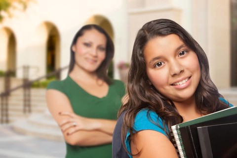 Proud Hispanic Mother and Daughter on Campus At School