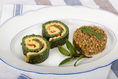 Southern German cuisine, polenta spinach roulade with alblentils served on serving platter, bay